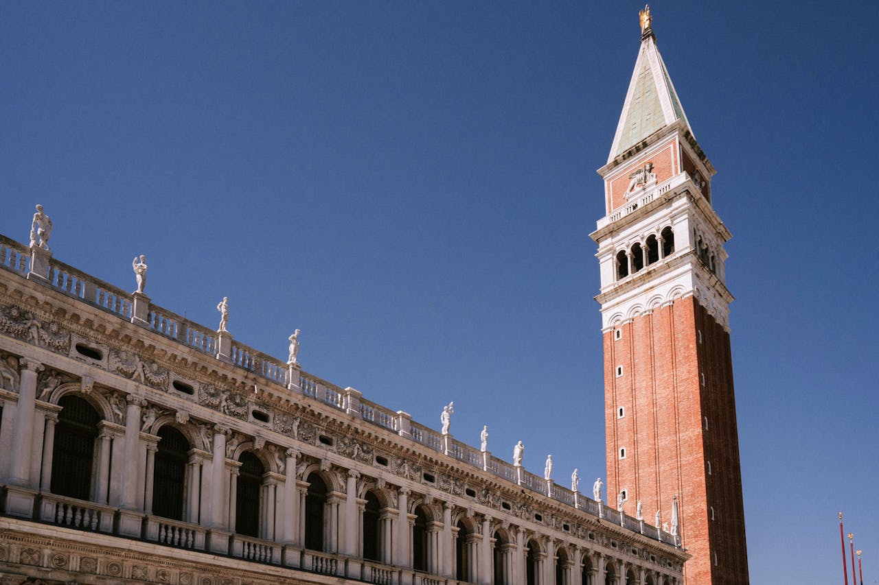 Iconic St. Mark's Campanile in Venice under clear blue skies.